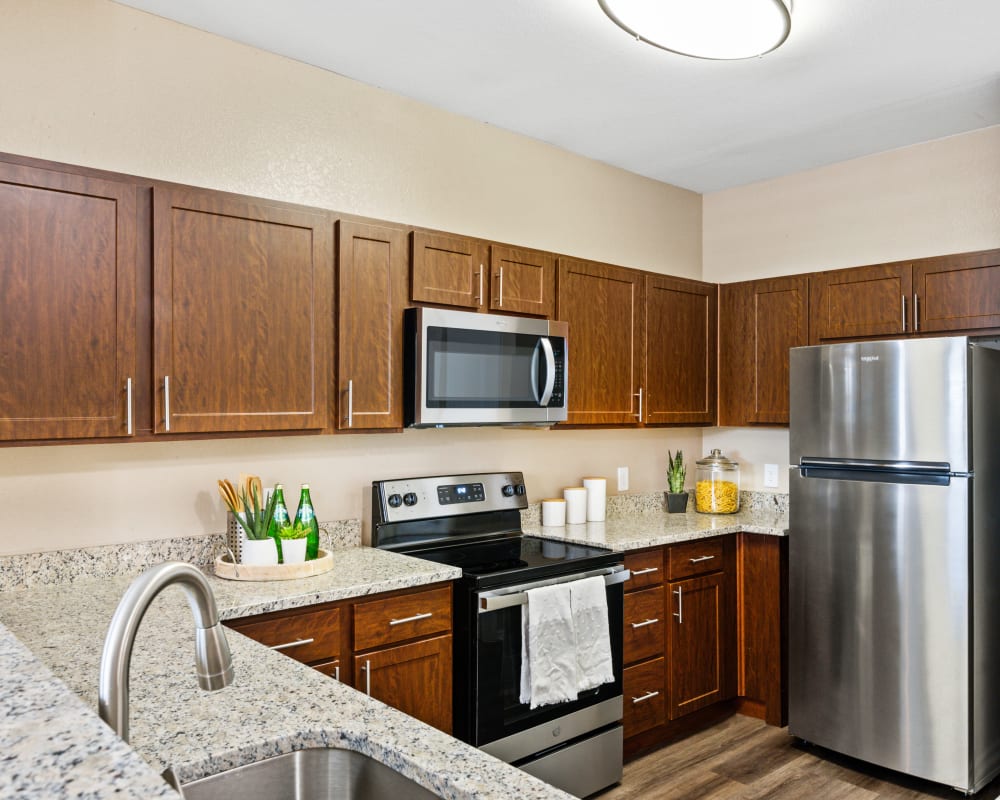 Kitchen with stainless steel appliances at El Lago Apartments 