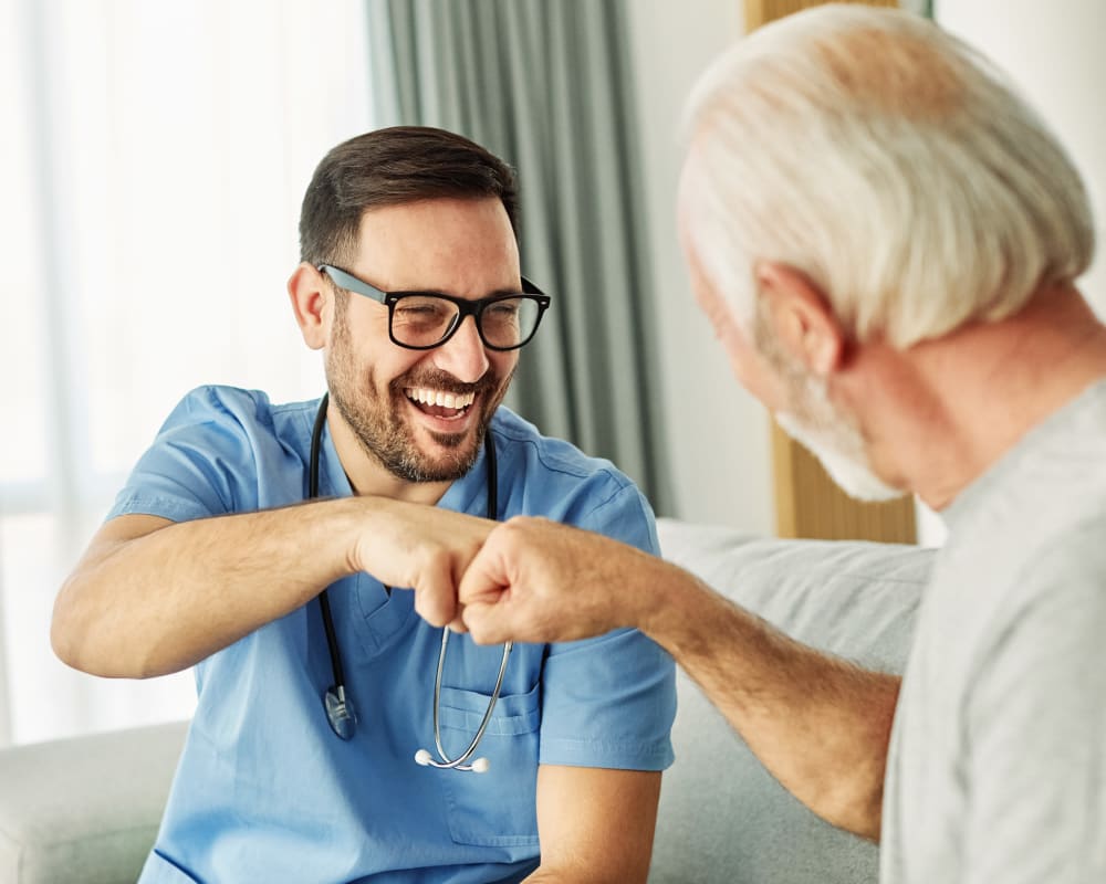 Resident fist bumping a team member at Integrated Senior Lifestyles in Southlake, Texas