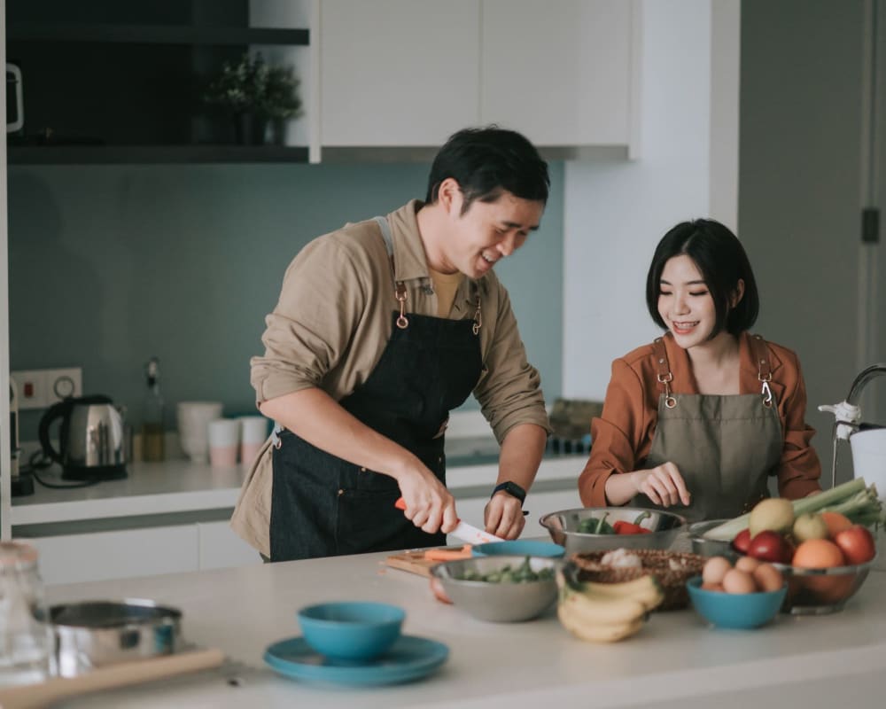 Couple cooking at 1408 Casitas at Palm Valley in Avondale, Arizona