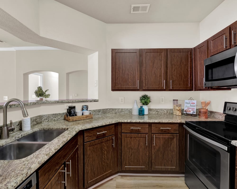 Kitchen with stainless steel appliances at The Estates of Northwoods in San Antonio, Texas