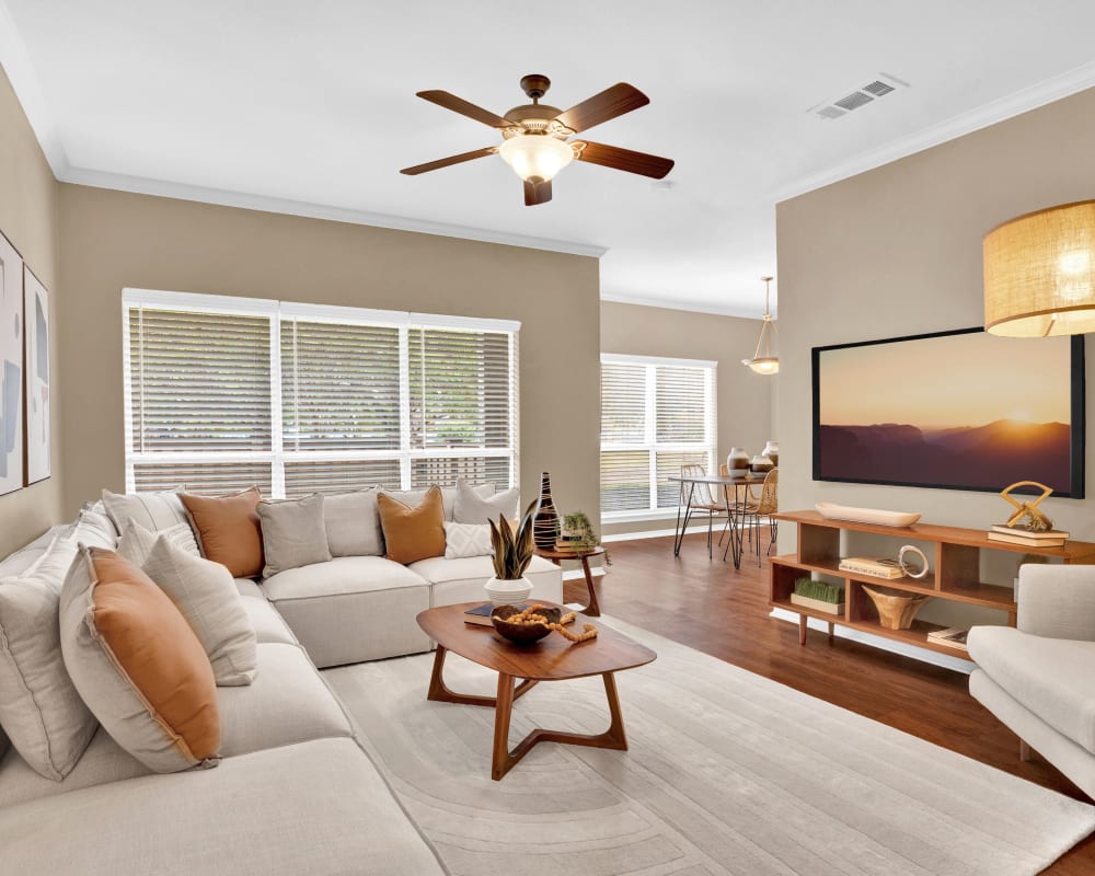 Living room with ceiling fan at Villas of Preston Creek in Plano, Texas