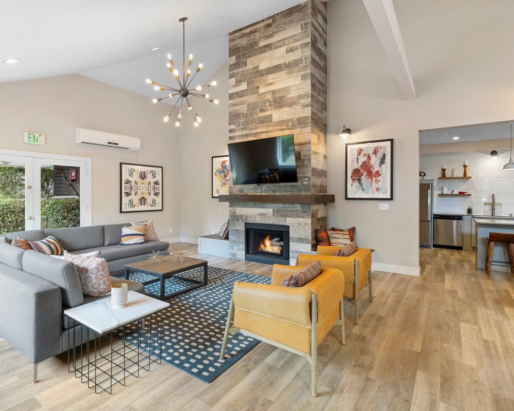 Resident lounge area with a fireplace and flatscreen TV in the clubhouse at Sofi at Somerset in Bellevue, Washington