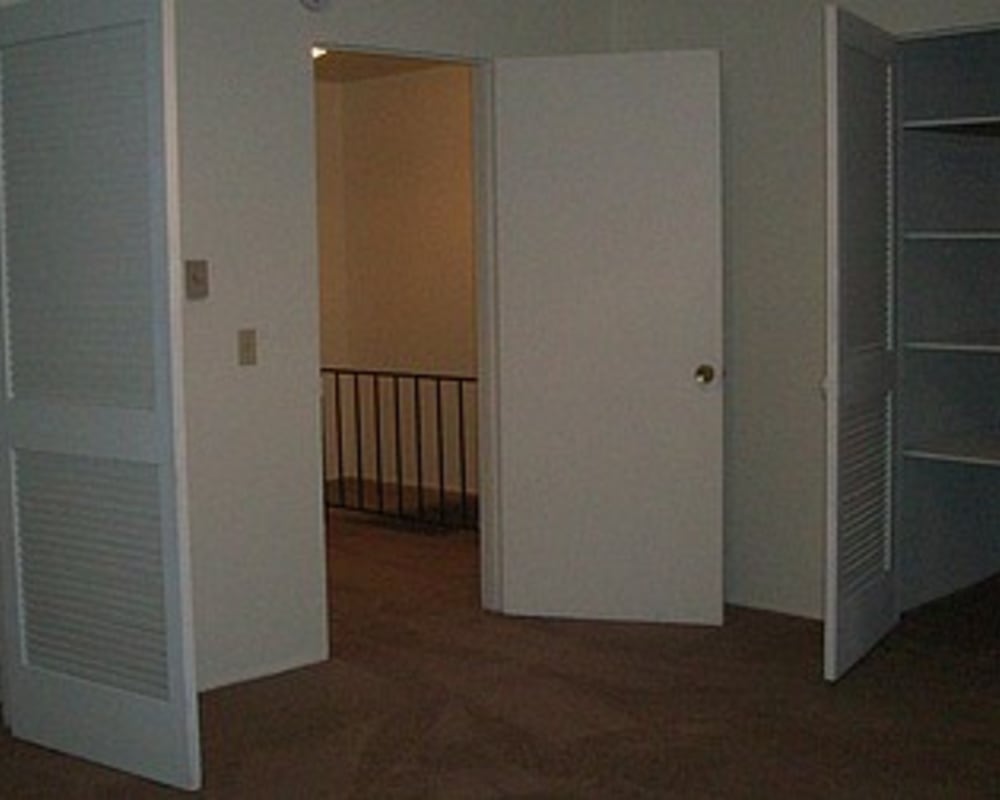 Model bedroom with closet at Park Hill Apartments in Seattle, Washington