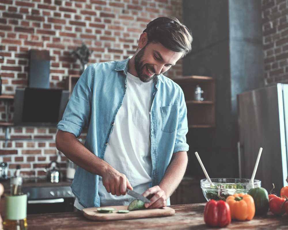Resident cooking in his gourmet kitchen at The Maggie Flats and The Maggie Towns in Jacksonville, Florida