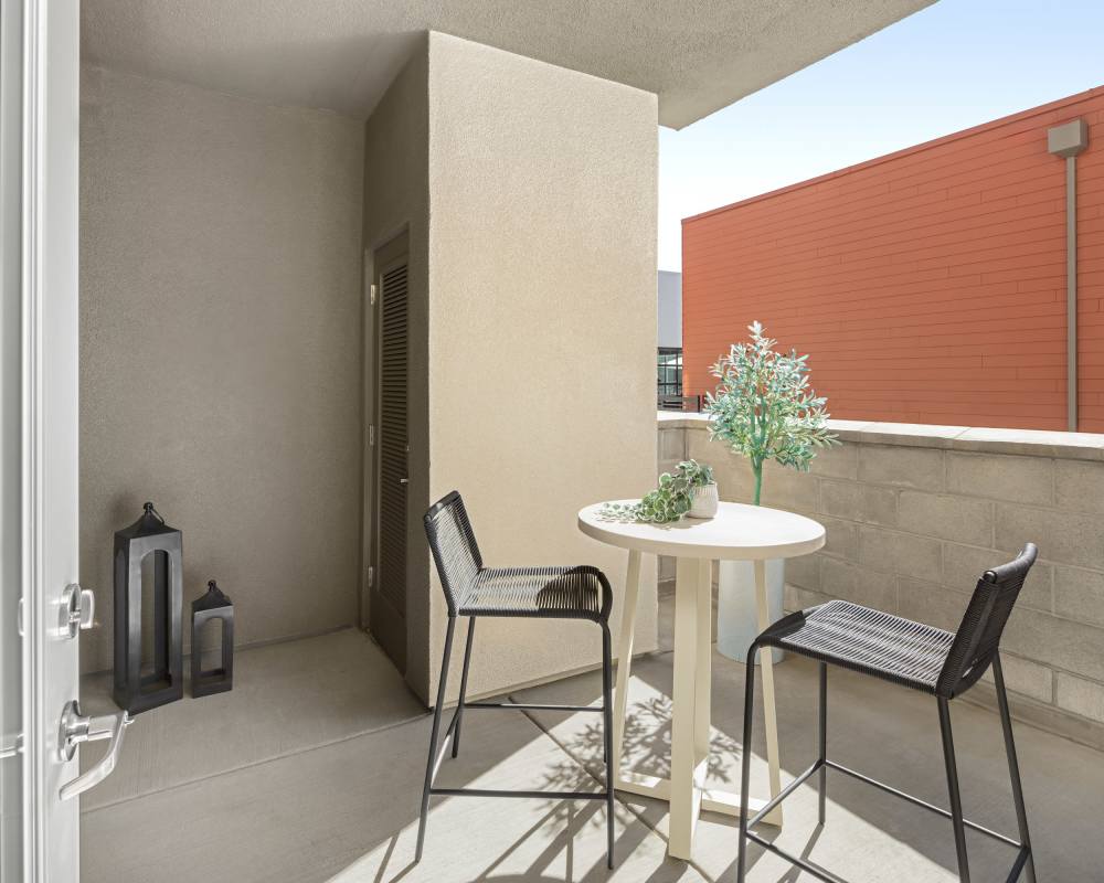 A balcony with chairs and table at SoCo Apartments in Napa, California