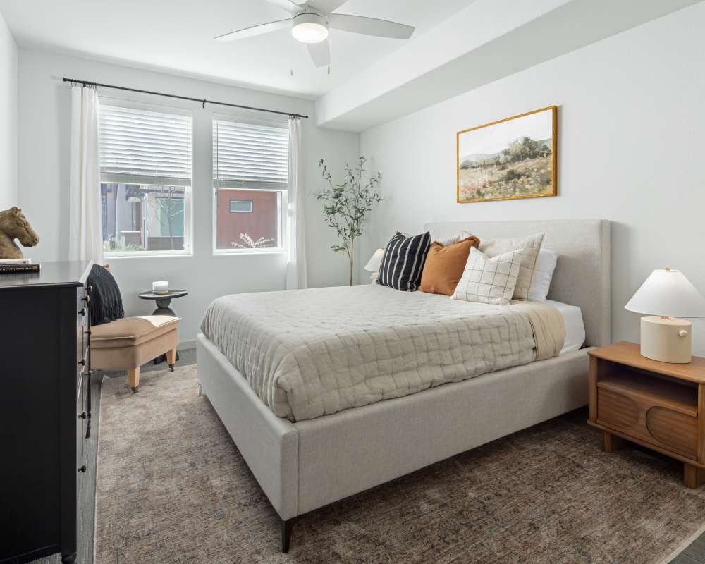 One-BR Apartments In Napa, CA - SoCo Apartments - Spacious Bedroom With High Vaulted Ceilings, Hardwood Flooring, Ceiling Fan, And Two Windows For Natural Sunlight
