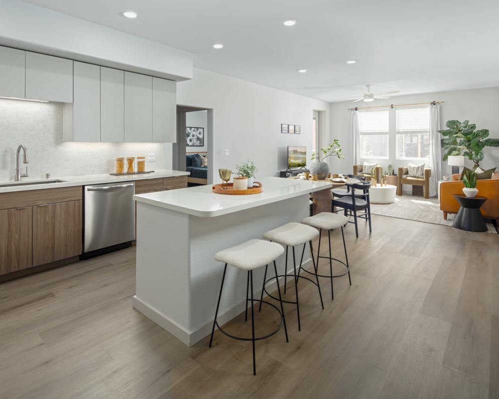 Modern kitchen with a white bar and stools at SoCo Apartments in Napa, California
