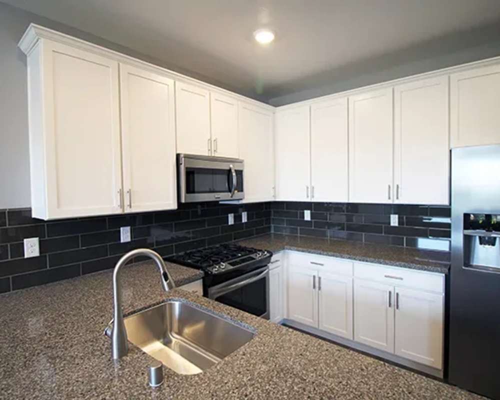 Stylish kitchen with stainless steel appliances and granite counter tops at Park Place Apartments in Reno, Nevada