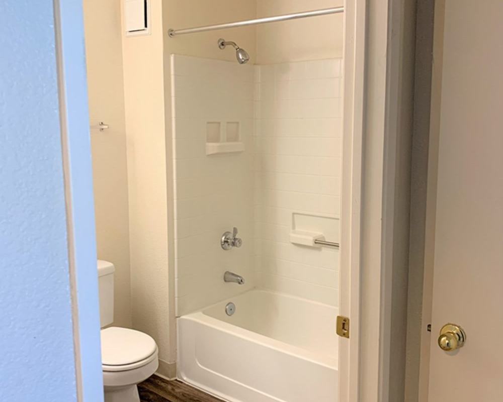 Bathroom with shower and tub at Somerset Senior Apartments in Antioch, California