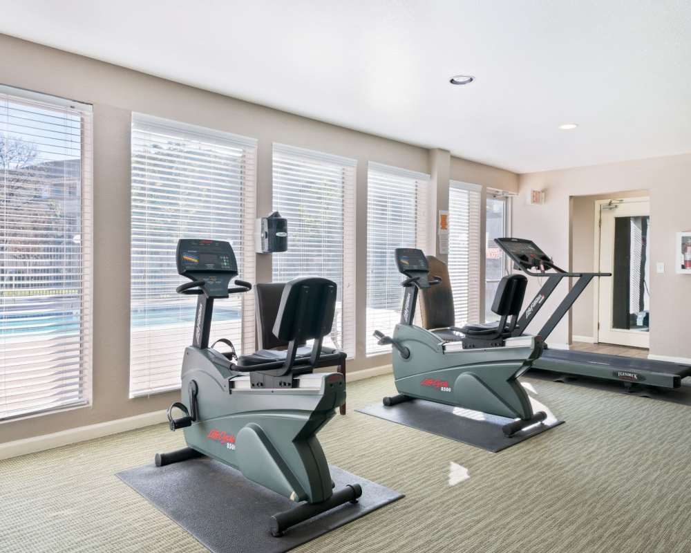 Fully-equipped gym with treadmills at Somerset Senior Apartments in Antioch, California