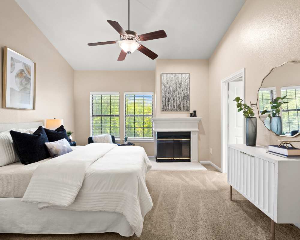 Bedroom with fireplace at Villas at Parkside in Farmers Branch, Texas
