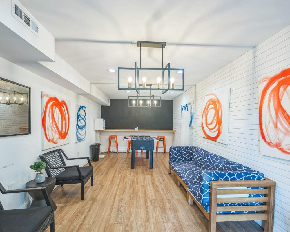 Lounge area in the game room by the foosball table at Eagle Rock Apartments at Towson in Towson, Maryland