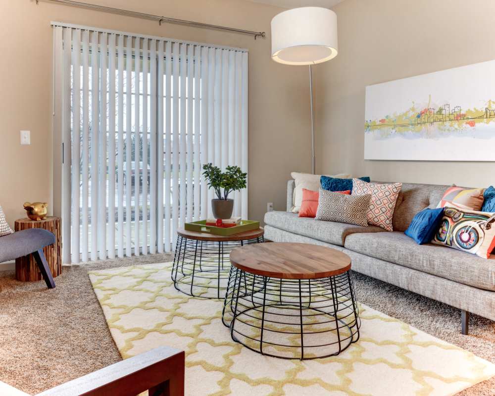 Spacious model living room with plush carpeting at Maple Oaks in Middletown, Ohio