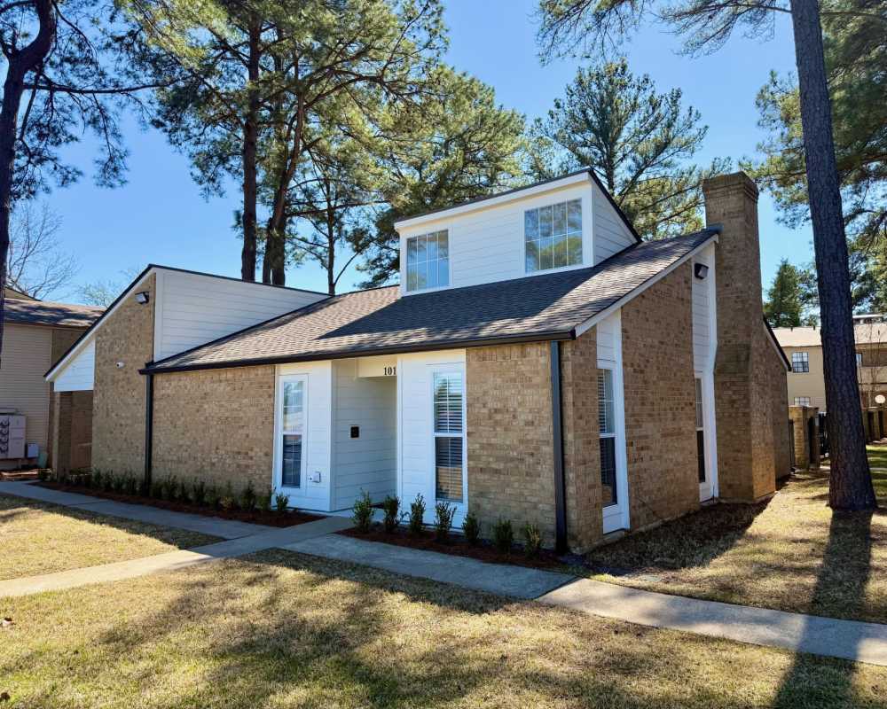 Apartment living room with chocolate colored furniture at Country Club Place in Marshall, Texas