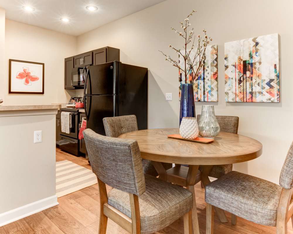 Dining area with a ceiling fan in a beautiful model home at Stonebridge Crossing Apartment Homes in Cordova, Tennessee