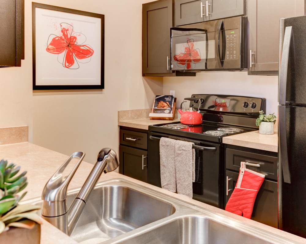 Model kitchen with a breakfast bar at Stonebridge Crossing Apartment Homes in Cordova, Tennessee