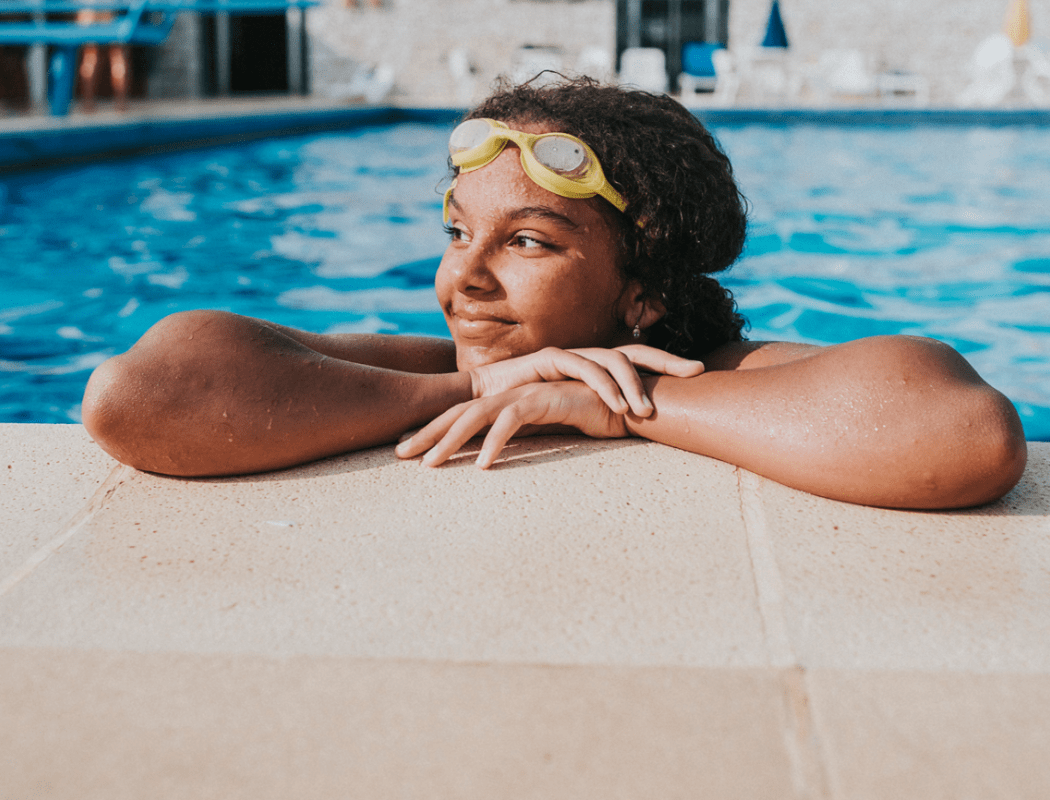 Woman swimming at pool at The Park at Waterford Harbor in Kemah, Texas