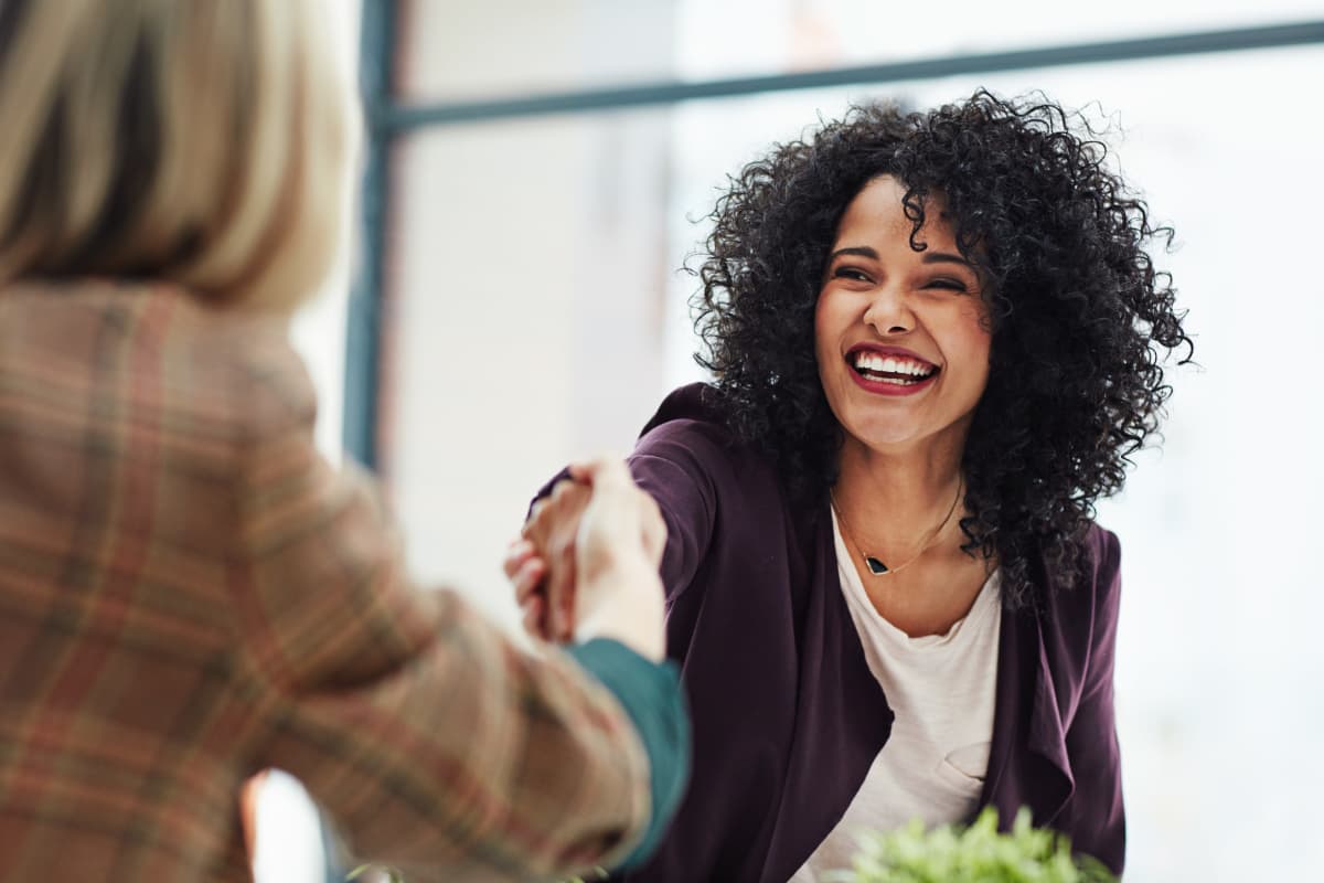 Woman shaking hands at First Realty Management in Boston, MA