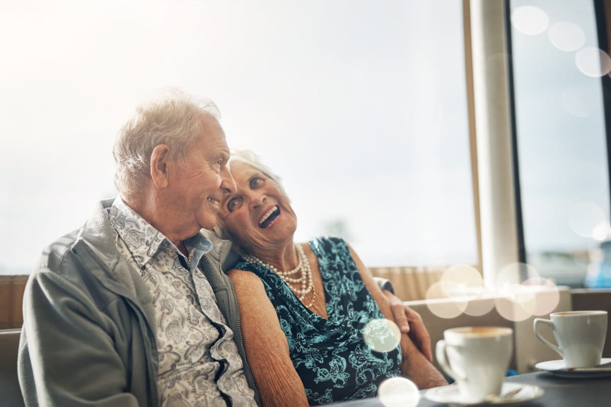 Senior couple laughing together at Sandpiper Courtyard in Mt. Pleasant, South Carolina