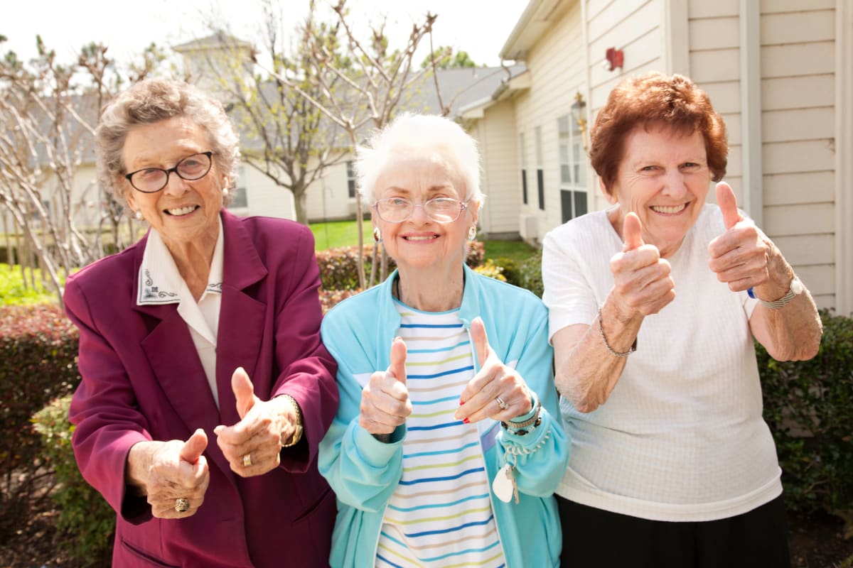 3 Residents giving a thumbs up at Beach House Assisted Living & Memory Care at Wiregrass Ranch in Wesley Chapel, Florida