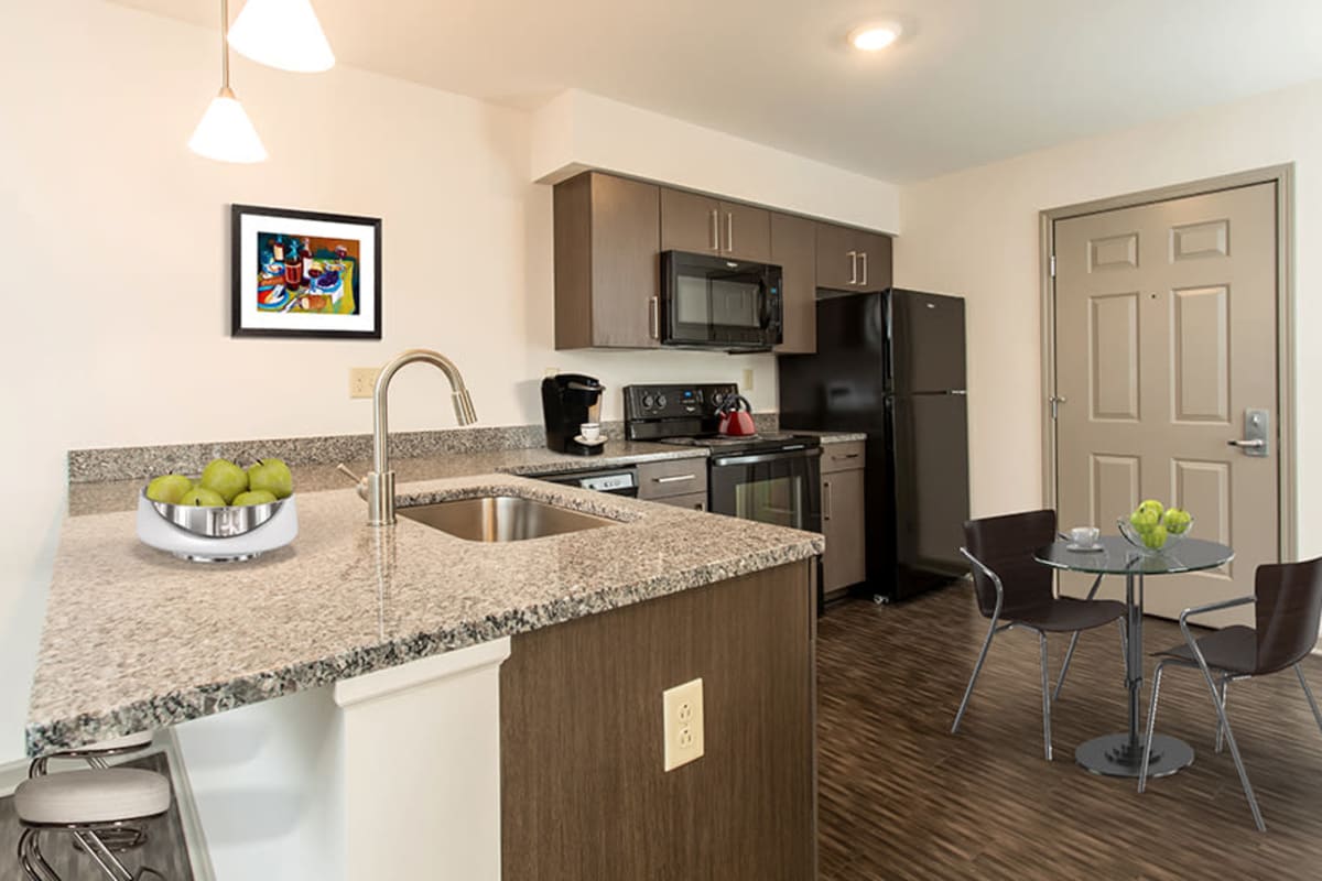 Fully-equipped kitchen at Greenwood Cove Apartments home in Rochester, New York