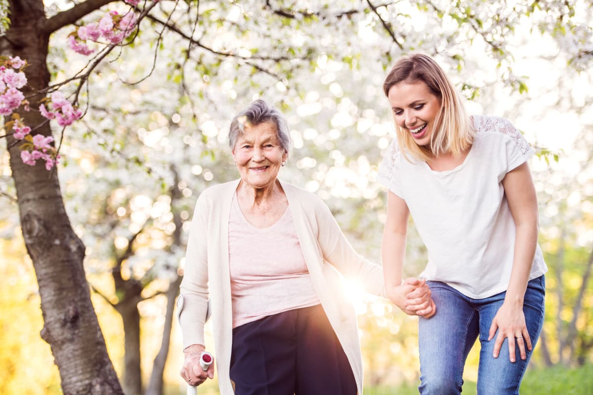 Resident holding hands with loved one at Cedar Crest Memory Care in Lafayette, Louisiana