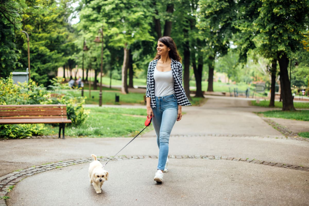 Resident walking her dog near 17th Street Lofts in Atlanta, Georgia