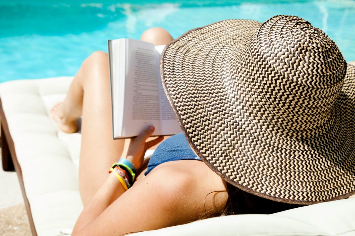 Resident reading by the pool at Courtney Isles in Yulee, Florida