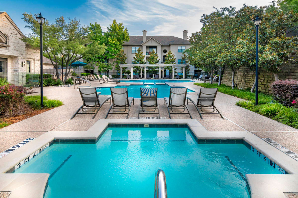 Chaise lounge chairs on the sundeck around the pool at Hyde Park at Montfort in Dallas, Texas