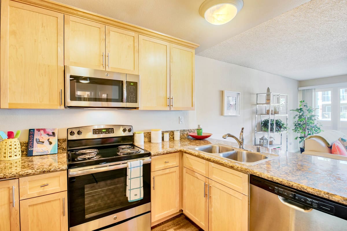 Ample cabinet and cupboard space in a model home's kitchen at The Tides at Marina Harbor in Marina del Rey, California