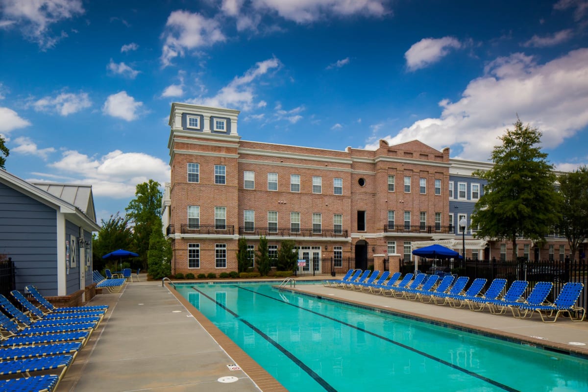 Large pool with lots of seating at Worthington Apartments & Townhomes in Charlotte, North Carolina