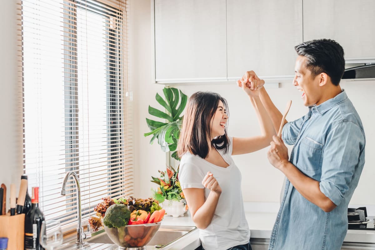 Couple chatting in their kitchen at The District Flats in West Palm Beach, Florida