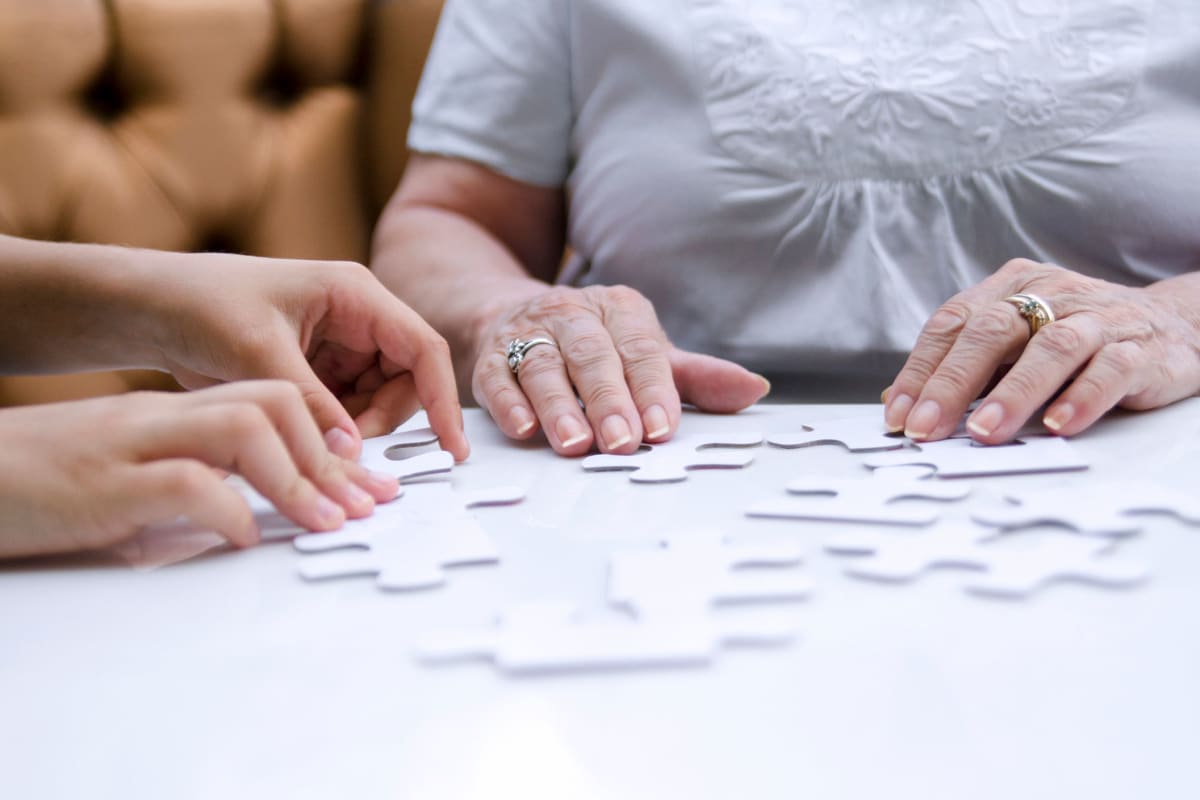 Resident solving a puzzle at Saddlebrook Oxford Memory Care in Frisco, Texas