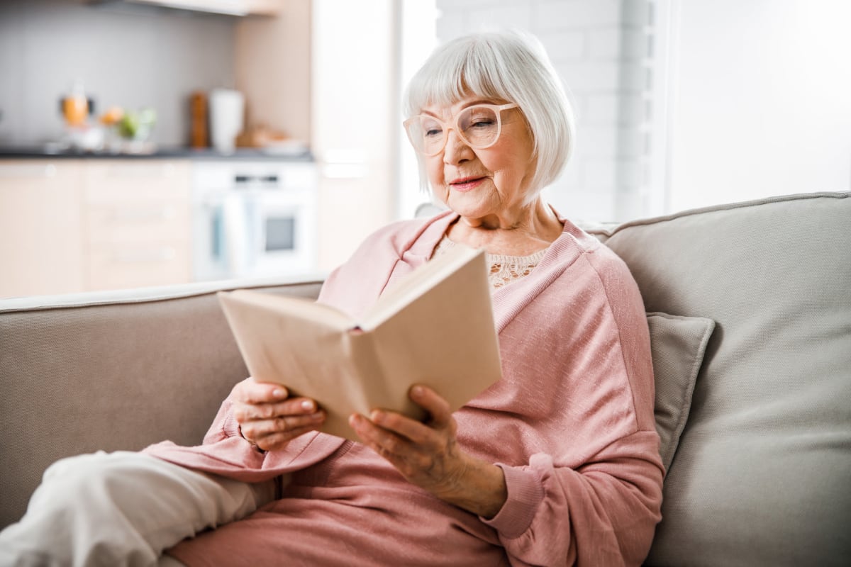 Resident reading a book at Saunders House in Wahoo, Nebraska