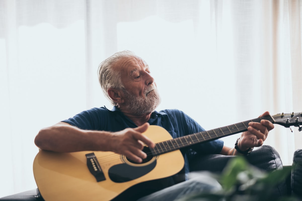 Resident playing guitar at Canoe Brook Assisted Living in Broken Arrow, Oklahoma