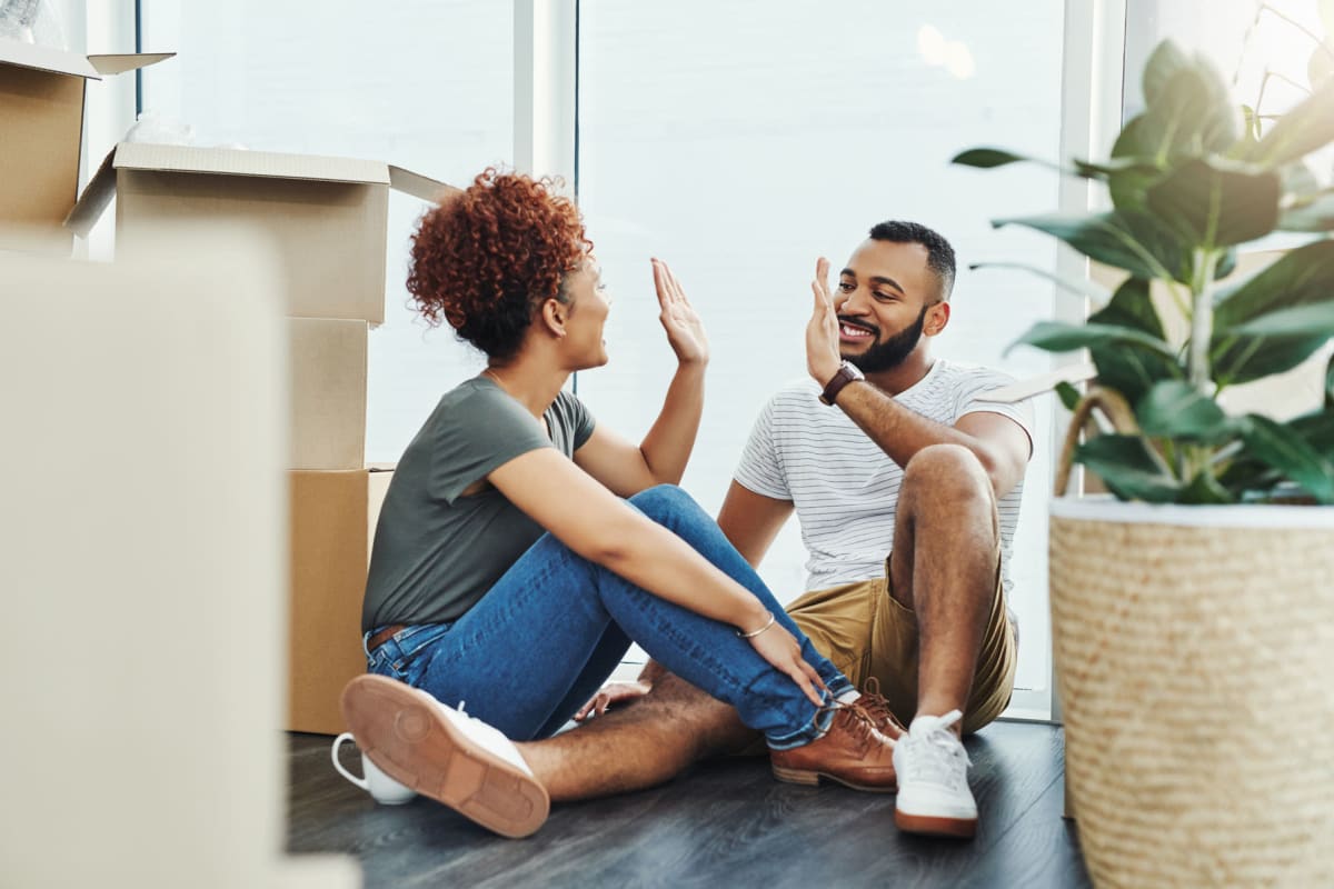 Residents taking a break from moving in and resting on the beautiful wood-style flooring of their new home at Solera at City Centre in Palm Beach Gardens, Florida