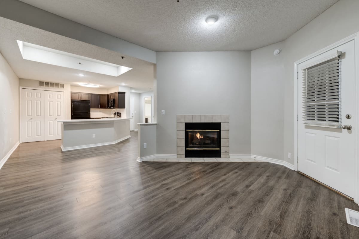 Bright living area with multiple windows and wood flooring at Ashford Belmar in Lakewood, Colorado