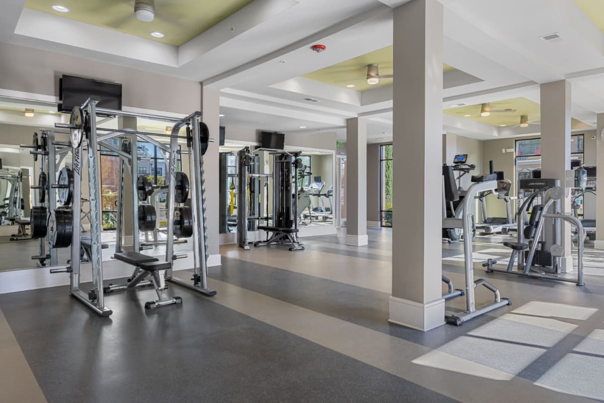Assisted bench press and weight machines in fitness room at Marq at Crabtree in Raleigh, North Carolina