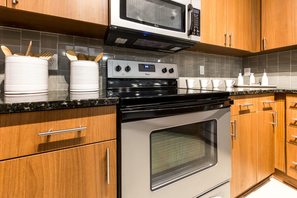 Stainless steel stove/oven and microwave with wood cabinets at Marq Eight in Atlanta, Georgia