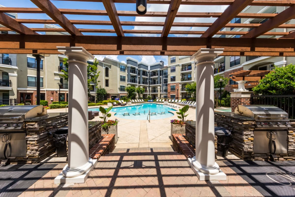 Covered BBQ grill area leading down to pool deck at Marquis Midtown District in Atlanta, Georgia