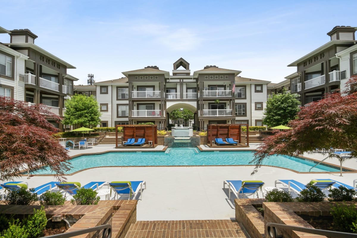 Beautiful resort style swimming pool with tons of lounge chairs at 45Eighty Dunwoody Apartment Homes in Dunwoody, Georgia