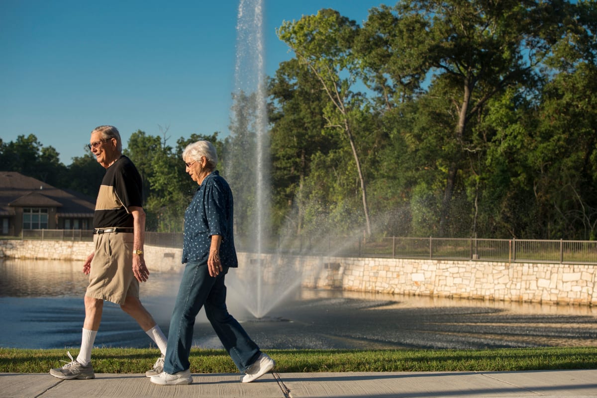 Couple going for a walk near The Reserve at Watermere Woodland Lakes in Conroe, Texas