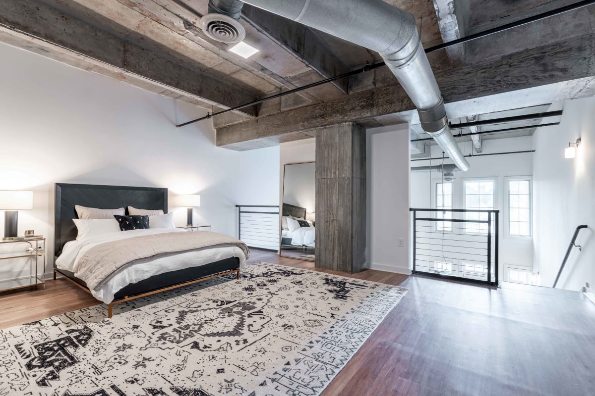 Spacious and well-furnished loft bedroom in a model home at 17th Street Lofts in Atlanta, Georgia
