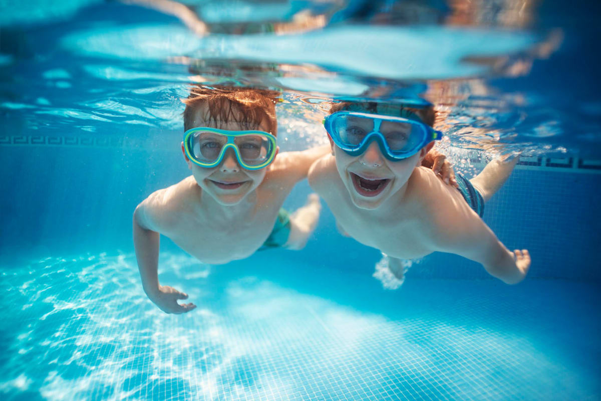 Residents enjoying the pool at Enchanted Springs Apartments in Colorado Springs, Colorado