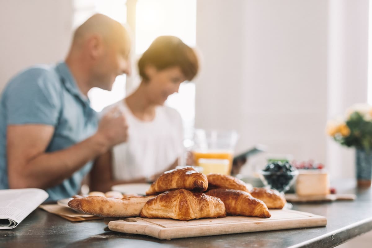 Couple enjoying a leisurely breakfast in their modern kitchen at The Pointe at Siena Ridge in Davenport, Florida