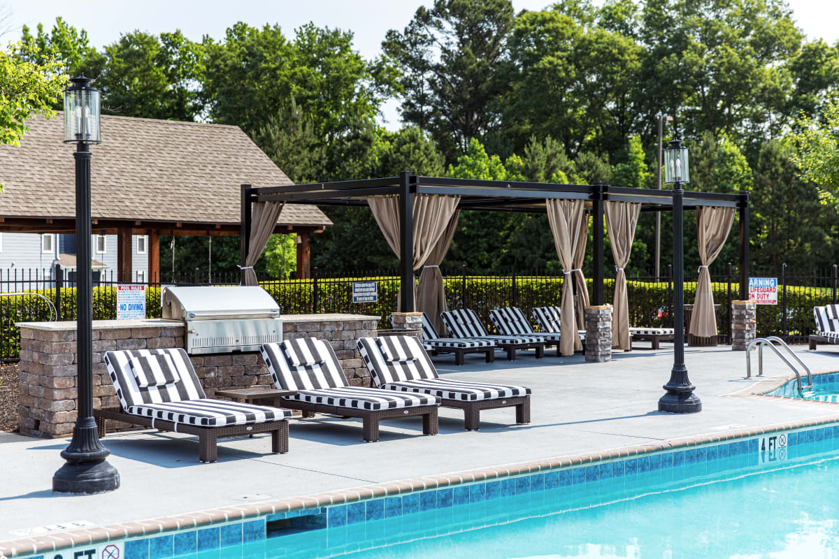Lounge chairs and cabanas by the resort-style pool at River Pointe in Carrollton, Georgia