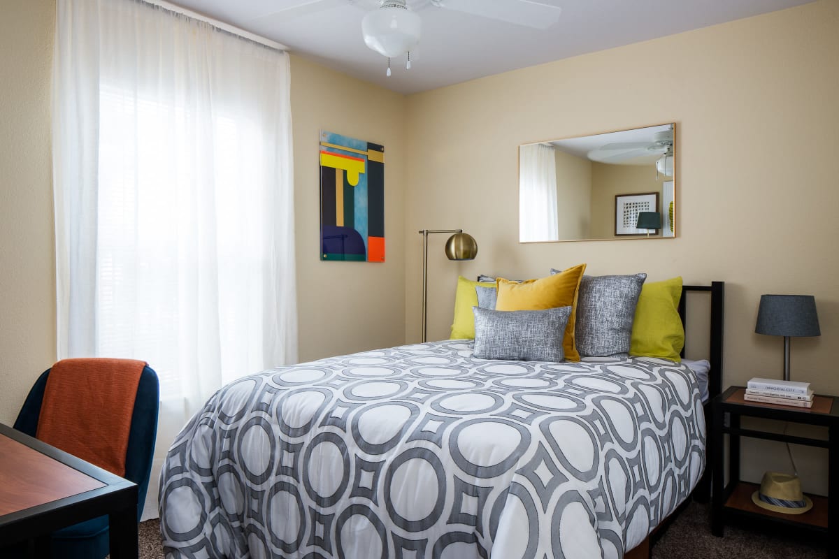 Sunny model bedroom with a desk at The Kristi in Corpus Christi, Texas