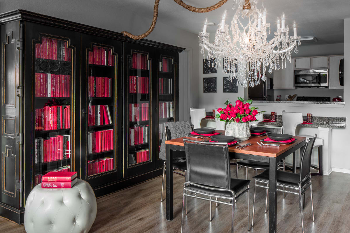 Dining room with a large bookcase in a model apartment at The London in College Station, Texas