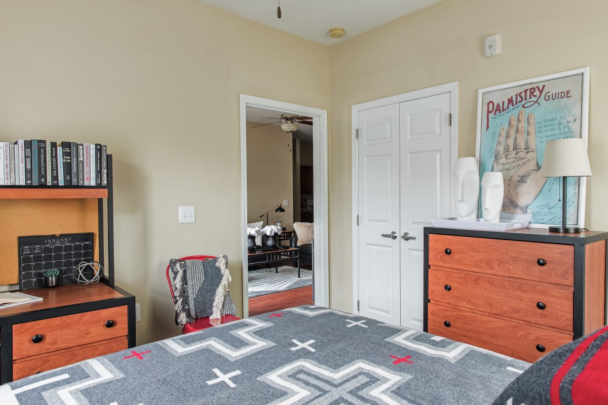 Model bedroom with a large closet and space for a desk and dresser at University Village in Greensboro, North Carolina