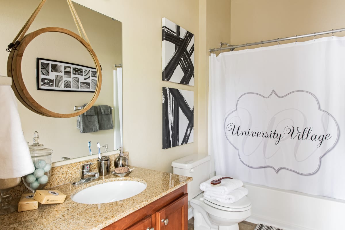 Model bathroom with a tub/shower combination and vanity at University Village in Greensboro, North Carolina